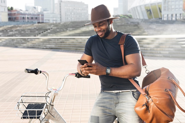 Handsome man checking his phone on a bicycle