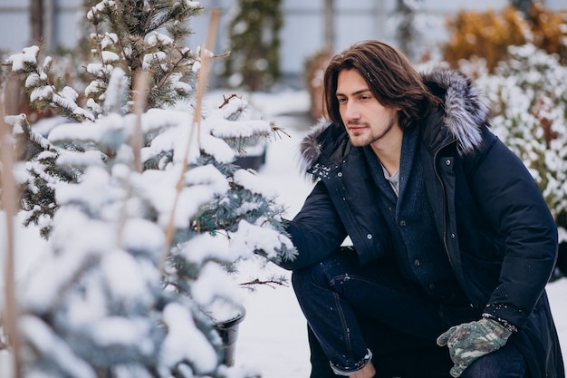 Handsome man choosing a christmas tree