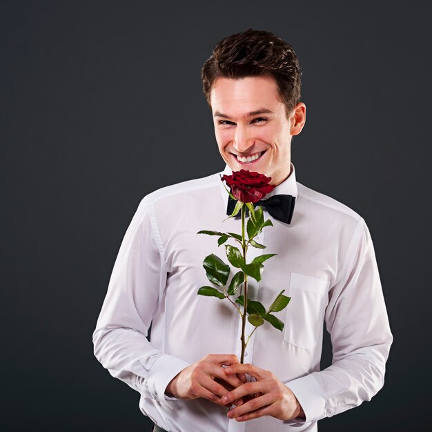 Handsome man on dark grey wall