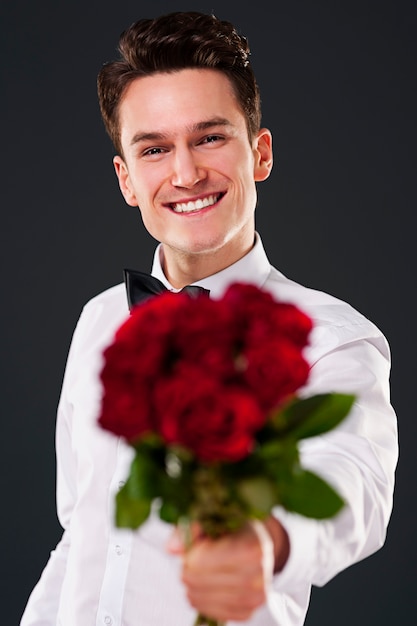 Handsome man on dark grey wall