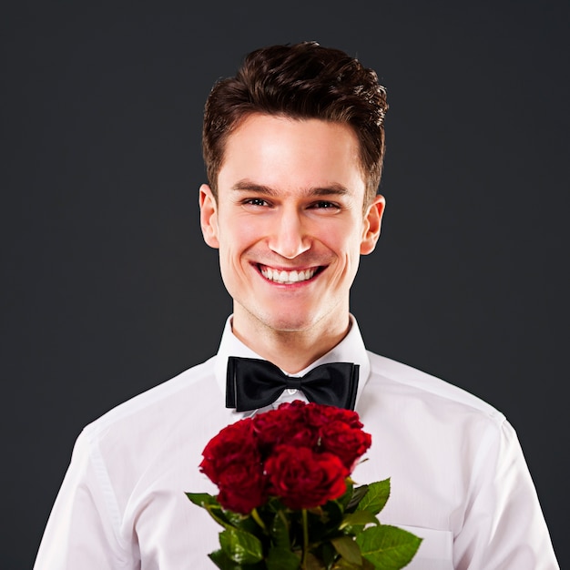 Handsome man on dark grey wall