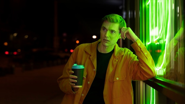 Handsome man drinking coffee during a night out