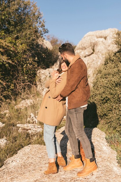 Handsome man embracing his girlfriend