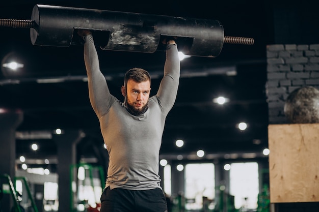 Handsome man exercising at the gym