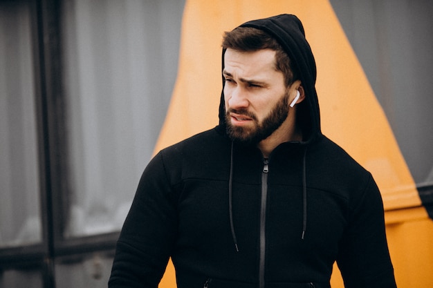 Handsome man exercising in park in sports wear