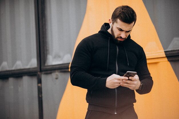 Handsome man exercising in park in sports wear