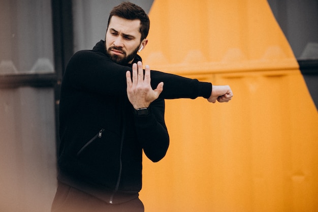 Free photo handsome man exercising in park in sports wear