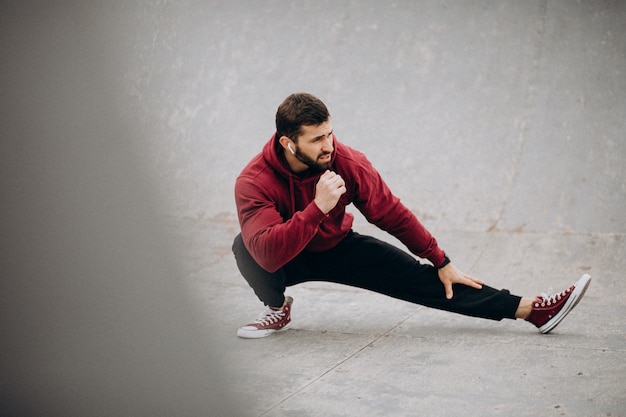 Handsome man exercising in park in sports wear