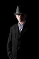 Free photo handsome man in hat in the dark