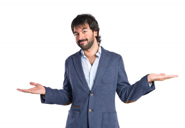 Handsome man having doubts over isolated white background