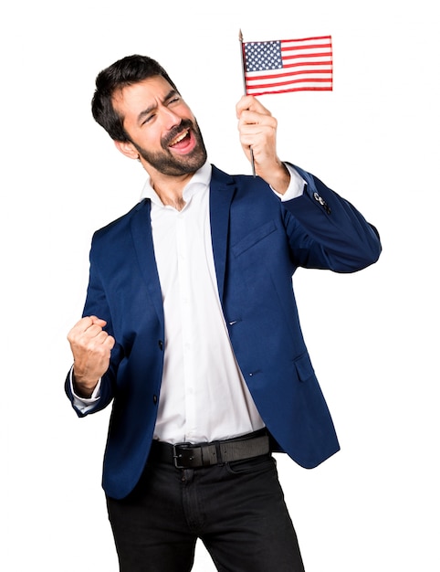 Free photo handsome man holding an american flag