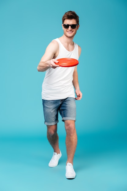 Handsome man holding beach summer toy.