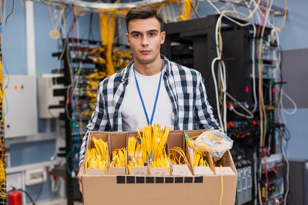 Handsome man holding a box with different optical fiber