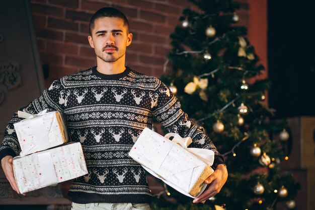 Handsome man holding Christmas peresents