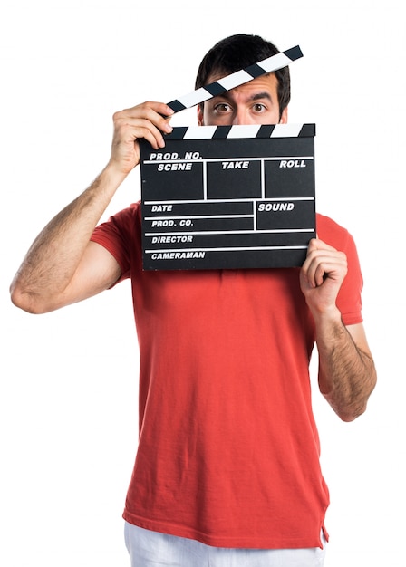 Free photo handsome man holding a clapperboard