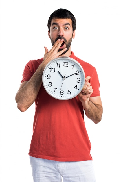 Handsome man holding clock