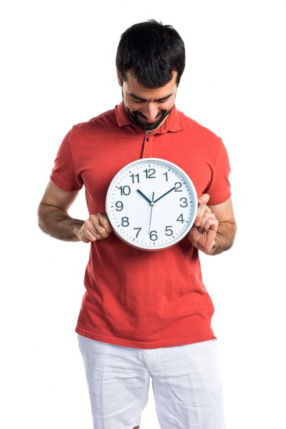 Handsome man holding clock