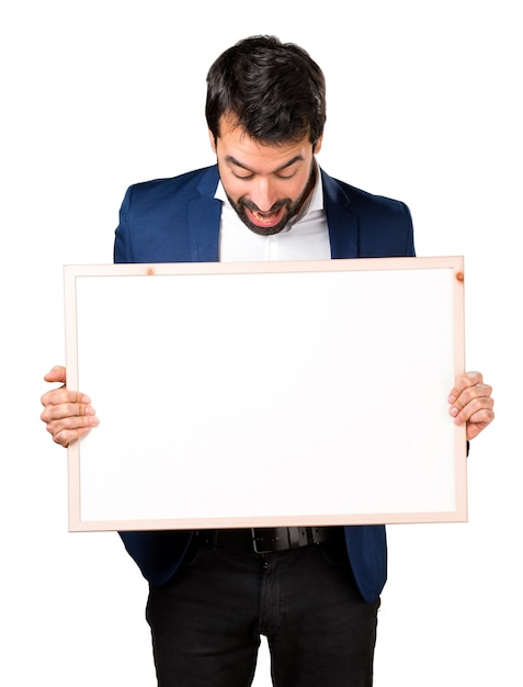 Handsome man holding an empty placard