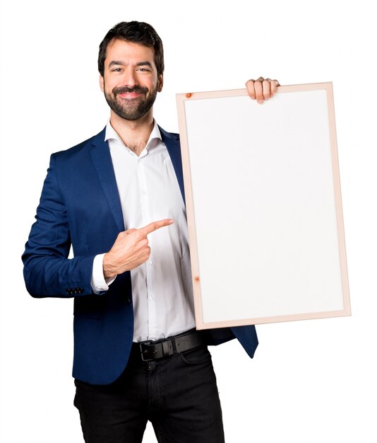 Handsome man holding an empty placard