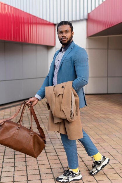 Handsome man holding his bag