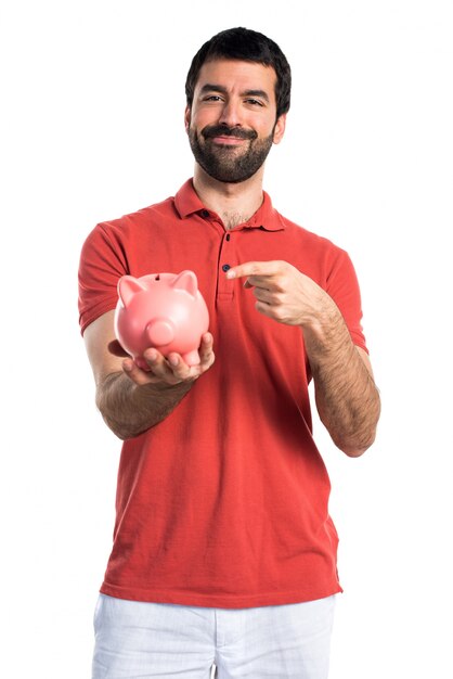 Handsome man holding a piggybank