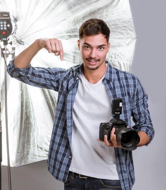 Handsome man holding a professional camera