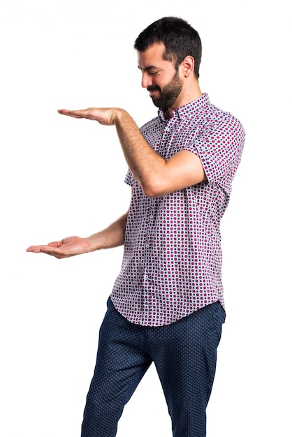 Free photo handsome man holding something