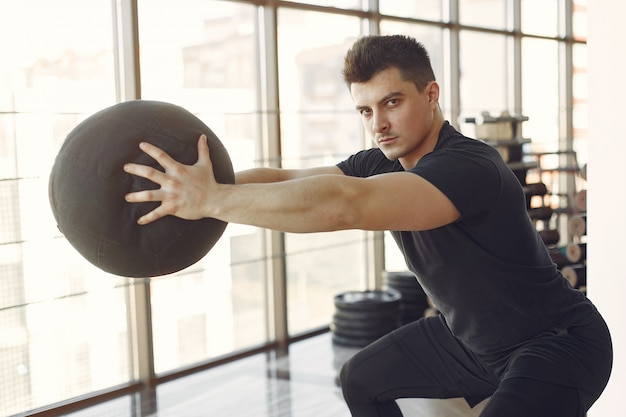 Free photo a handsome man is engaged in a gym