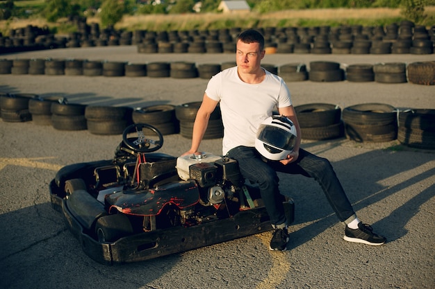 Handsome man in a karting with a car