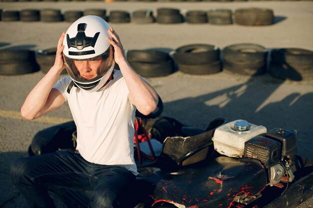 Handsome man in a karting with a car