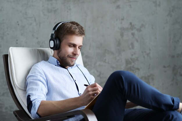 Handsome man listening music on headphones