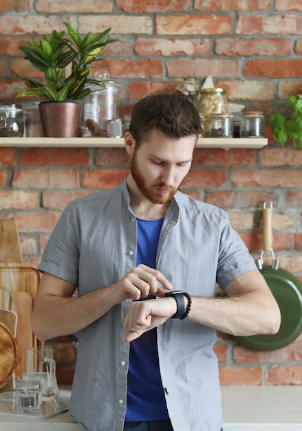 Handsome man looking at his wrist watch