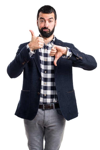 Free photo handsome man making good-bad sign