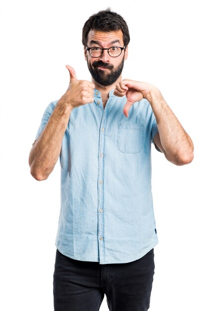 Handsome man making good-bad sign