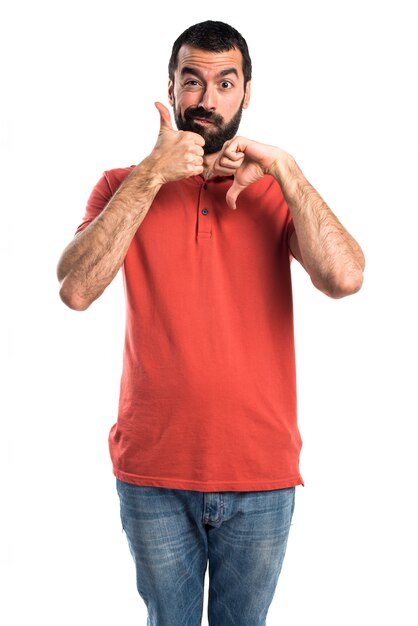 Handsome man making good-bad sign