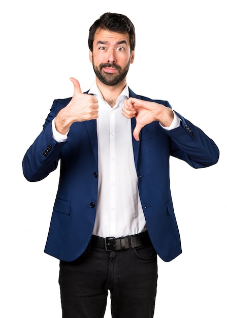 Free photo handsome man making good-bad sign