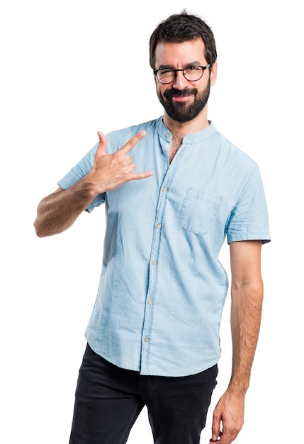 Handsome man making horn gesture