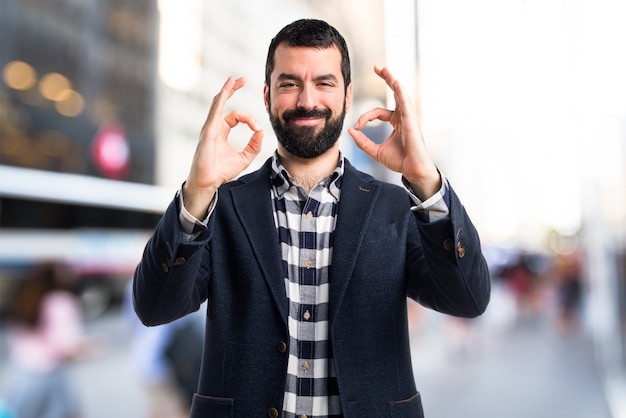 Free photo handsome man making ok sign