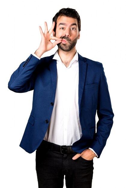 Handsome man making silence gesture