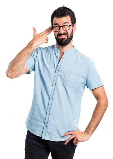 Handsome man making suicide gesture