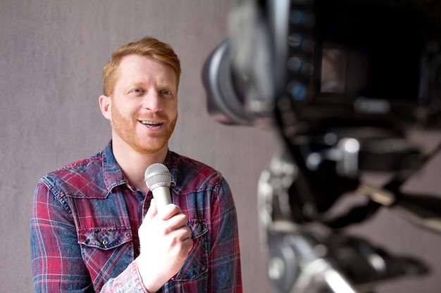 Handsome man making video talking in mic