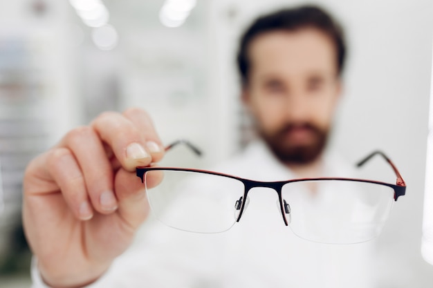 Free photo handsome man in a optics shop