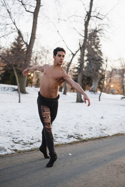 Handsome man performing ballet outdoor