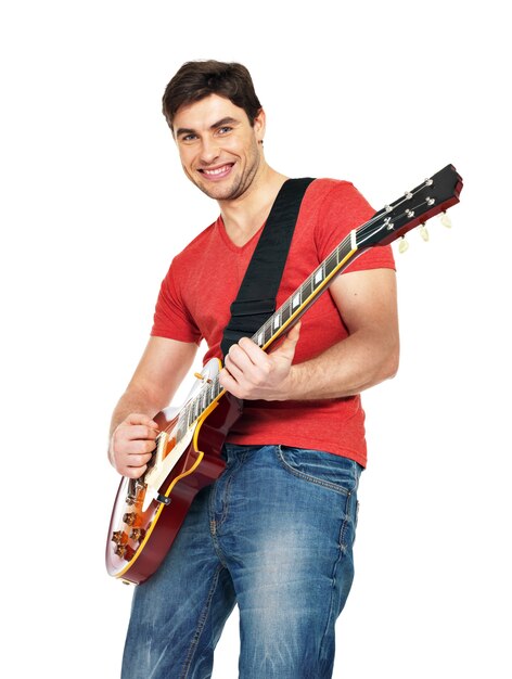 A handsome man plays on electric guitar with bright emotions, isolate on white