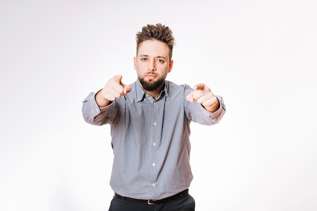 Free photo handsome man pointing at camera