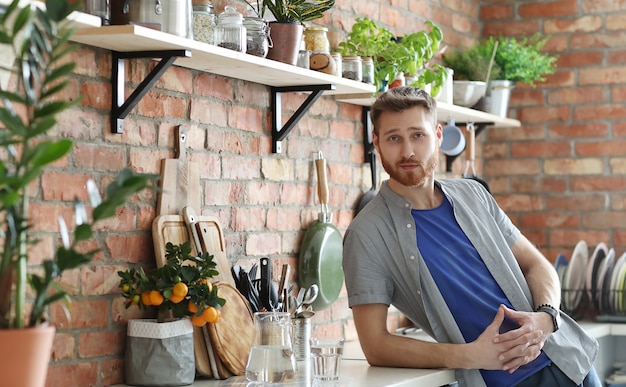 Handsome man posing in kitchen