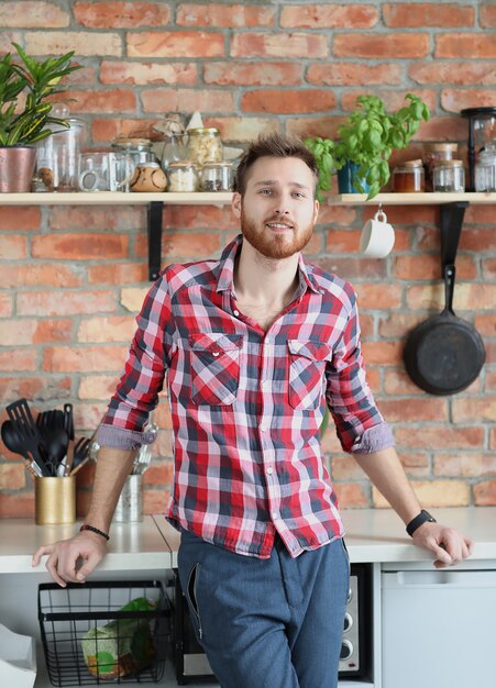 Handsome man posing in kitchen