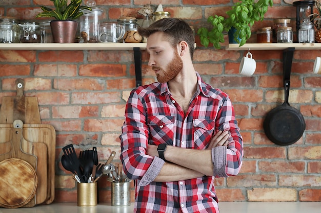 Free photo handsome man posing in kitchen