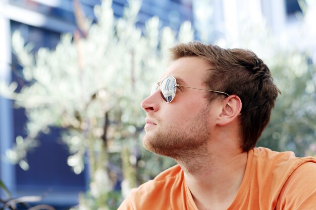 Handsome man posing in sunglasses