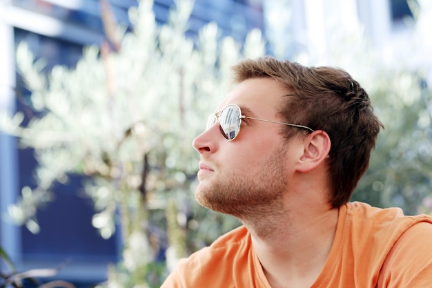 Handsome man posing in sunglasses